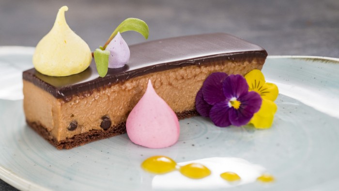 Crisp Caramel Chocolate Mousse Bar, Flavored Merengue Kisses and Passion Fruit Sauce ©Disney