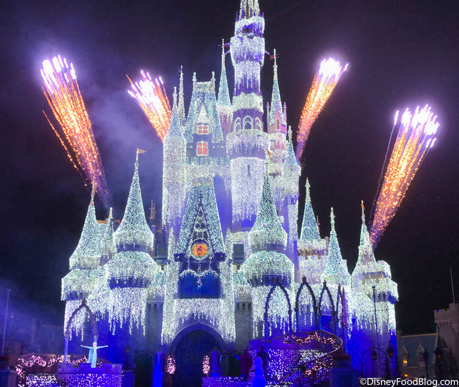 Like An Icy Blast Elsa Lights Up Cinderella Castle For The Christmas Season In Disney World The Disney Food Blog