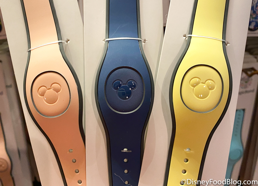 https://www.disneyfoodblog.com/wp-content/uploads/2021/01/WDW-2021-Magic-Kingdom-Frontier-Trading-Co-Pale-Yellow-Pink-Navy-Blue-MagicBands.jpg