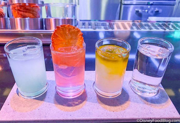 https://www.disneyfoodblog.com/wp-content/uploads/2022/02/2022-wdw-walt-disney-world-star-wars-galactic-starcruiser-hotel-media-preview-sublight-lounge-cantina-chronicles-drink-blue-milk-citrus-fizz-mooja-twist-poison-spitter-33-700x480.jpg