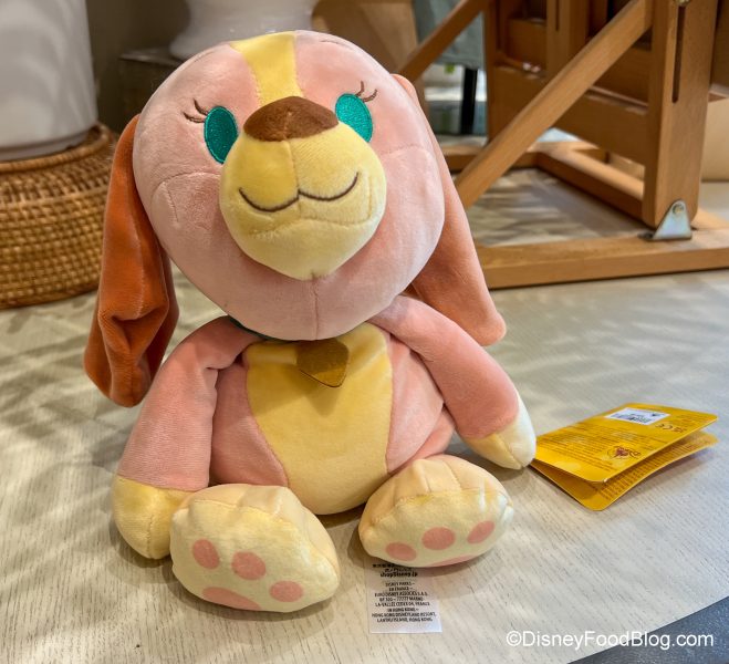 https://www.disneyfoodblog.com/wp-content/uploads/2022/04/2022-dlr-dtd-world-of-disney-weighted-plush-lady-659x600.jpg