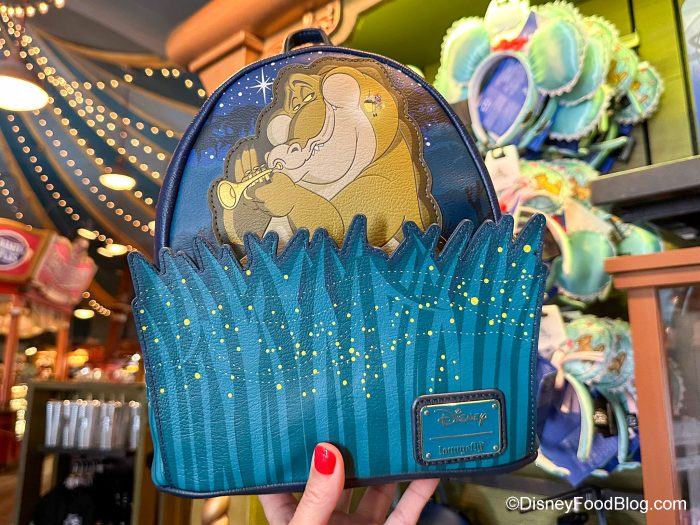 https://www.disneyfoodblog.com/wp-content/uploads/2023/10/2023-wdw-mk-big-top-souvenirs-decades-princess-and-the-frog-louis-and-ray-loungefly-mini-backpack-1-700x525.jpg